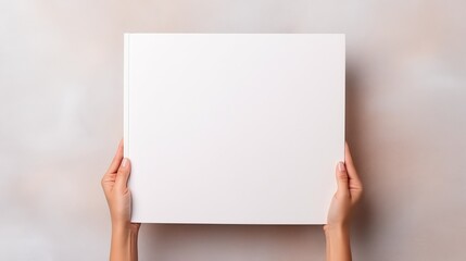 Female Hands Holding a Big Open Blank Book. Horizontal.