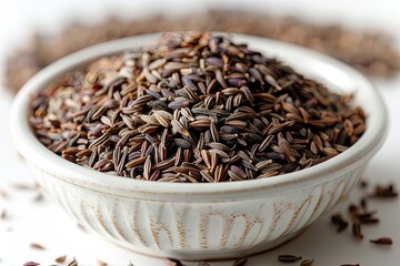 Cumin seeds or caraway in white bowl on gray background. close-up