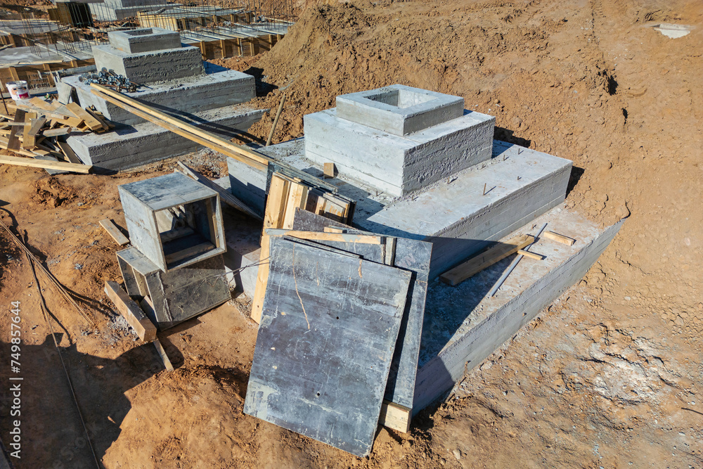 Poster a cluster of concrete blocks rests on a barren dirt field, ready for use in a construction project