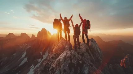 Fotobehang Climbers celebrating summit ascent. Team jubilant against mountain backdrop at sunset, conveying triumph. © Postproduction