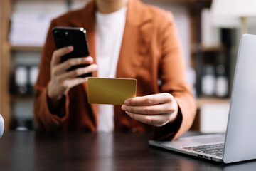 businesswoman hand using smart phone, tablet payments and holding credit card online shopping, omni channel, digital tablet