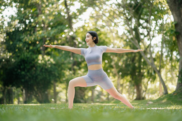 Portrait of young woman practicing yoga in garden.female happiness.  in the park blurred background.