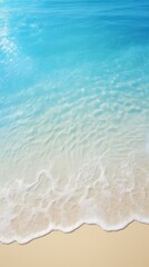 abstract sand beach from above with light blue transparent water wave and sun lights, summer vacation background concept banner with copy space, natural beauty spa outdoors 