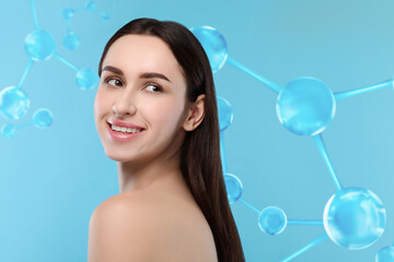 Beautiful woman with perfect healthy skin and molecular model on light blue background. Innovative...