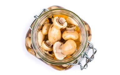 Fototapeta na wymiar Pickled mushrooms champignons in a glass jar. Isolated on white background