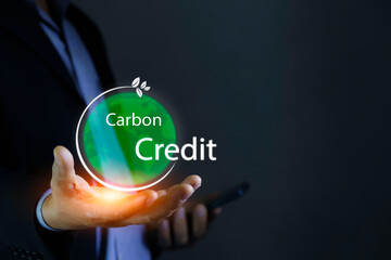Carbon Credit Market and Net Zero in 2050. Carbon credit icon in hand on green background. Icon energy and environmental protection round green energy neutral carbon Net zero greenhouse gas emissions
