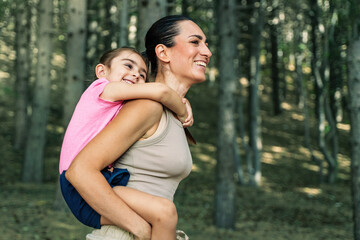 Fototapeta premium Joyful Mother-Daughter Embrace in Nature