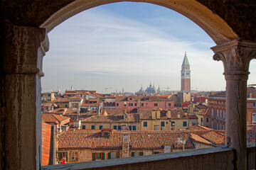 VENICE, ITALY, February 3, 2024 : View of the roofs and campanile from the top of the famous staircase of Palazzo Contarini del Bovolo - obrazy, fototapety, plakaty