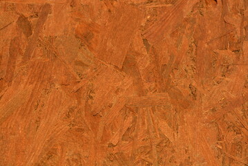 Construction oriented chipboard covered with brown varnish, original woody background plate.