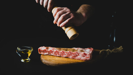 the chef adds spices to the meat
