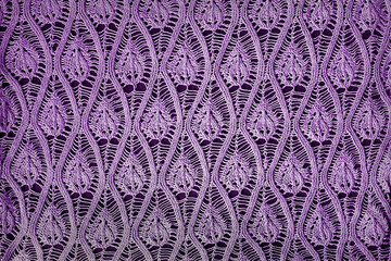 Textured lilac openwork close-up knitted on needles. Lilac patterned background - obrazy, fototapety, plakaty