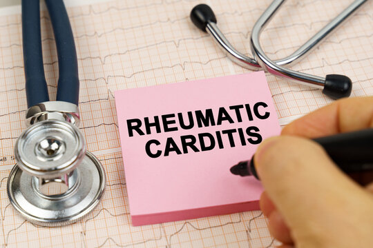On the cardiograms there is a stethoscope and a sticker with the inscription - Rheumatic carditis