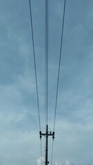 Industrial background of electricity pole with blue sky as the background