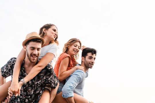 Friends Enjoying Piggyback Fun Outdoors