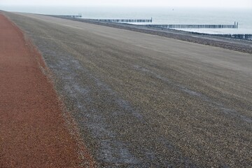 asphalted dune with breakwater on the north sea