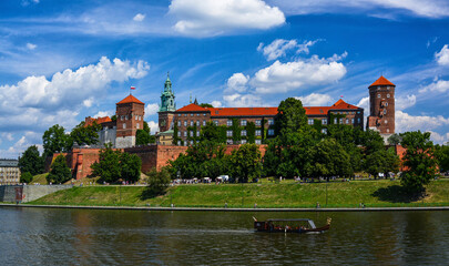 Naklejka premium Front view of Wawel castle in Krakow, Poland with boats on Vistula river at summer time.