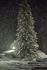 Russia. Kuznetsk Alatau. Night snowfall in a taiga mountain village far from the cities.
