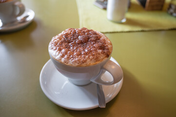 cappuccino with a large milk cap sprinkled with cocoa powder. coffee milk drink with caffeine and...