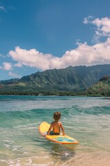 A boy with his surfboard in Hawaii