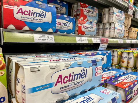 Kinds of Actimel yogurt drink displayed on the shelves of a supermarket. Actimel is a probiotic yogurt-type drink produced by the French company Danone.