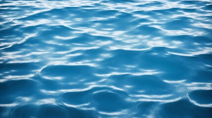 Blue water's surface adorned with gentle ripples creating beautiful patterns 