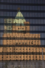 the fairmont hotel vancouver building is reflected in glass facade