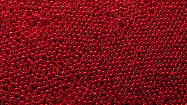 Red metal balls texture close-up.