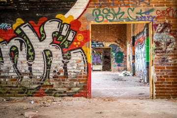 Walls covered in graffiti in an abandoned factory