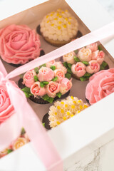 Delicious Gourmet Cupcakes Topped with Buttercream Frosting Flowers