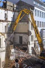 Fototapeta na wymiar A bulldozer is demolishing an old building in Vienna