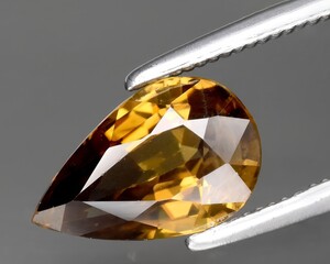 natural yellow zircon gem on the background
