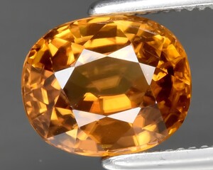 natural yellow zircon gem on the background