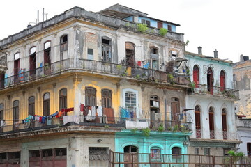 Fototapeta na wymiar Tenement house on the Villegas and Lamparilla streets corner, Old Havana, with cast-iron railing balconies and drying laundry. La Habana-Cuba-039
