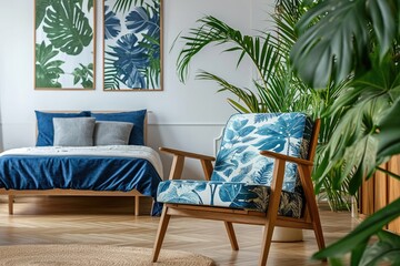 Cozy Bedroom Interior with Wooden Armchair, Blue Bed, and Green Plant. Real Life Snapshot of Simple and Design-Centric Apartment Decor - obrazy, fototapety, plakaty