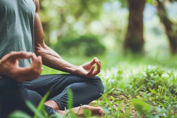 Poster Young unrecognizable Caucasian male man guy sportsman bodybuilder sportswear meditating lotus position zen gesture outdoors nature forest park. Yoga exercises meditation sport lifestyle mental health © Yuliia
