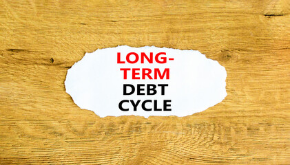 Long-term debt cycle symbol. Concept words Long-term debt cycle on beautiful white paper. Beautiful wooden background. Business Long-term debt cycle concept. Copy space.