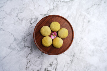 Kurabiye cookies served on wooden tray on a marble background