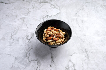 Mixed nuts in bowl, top view. Mix of various nuts