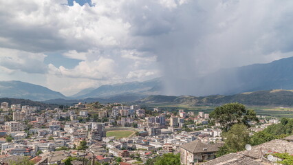 Fototapeta na wymiar Panorama showing Gjirokastra city from the viewpoint with many typical historic houses of Gjirokaster timelapse.