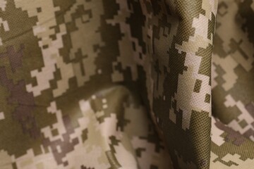 Texture of crumpled camouflage fabric as background, closeup
