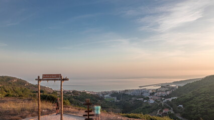 Fototapeta na wymiar Panorama showing aerial View of Sesimbra Town and Port during sunset timelapse, Portugal.