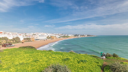 Wide sandy beach and Atlantic ocean in city of Albufeira timelapse. Algarve, Portugal