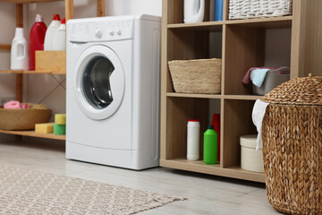 Laundry room interior with washing machine and furniture