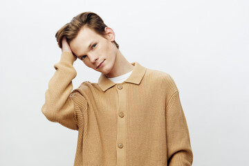 Young man with headache; man in beige shirt feeling unwell; tired young adult; migraine episode;...