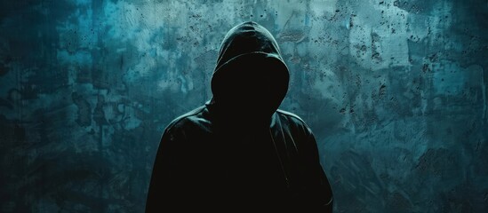 A mysterious hacker man in the hoodie in front of dark concrete background. Generated AI