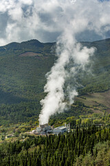 Vapor coming out of the chimney of thermal power plant, Tuscany, Italy, Europe, EU. Environmental and eco theme