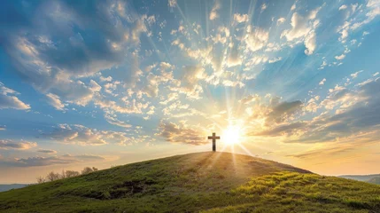 Fotobehang This dramatic Easter Morning Sunrise panorama with blue sky, bright clouds, sunbeams, and large cross on a grass covered hill makes a great banner cover for print or web. © buraratn