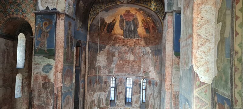 Ukrainian famous church of XII century. Cyril medieval church - today a museum. Scenic light in the dark. Heritage ancient and modern fresque on the walls.