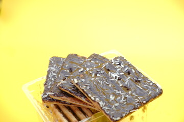 cracker biscuits with chocolate coating. biscuit cracker isolated on yellow background.