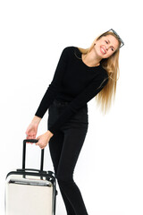 Pretty young woman pulling her heavy suitcase on white background. - 749943043